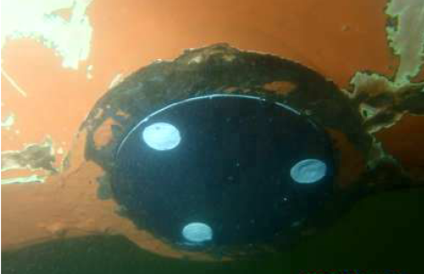 Round transducer cover fitted flush in a ship's hull underwater