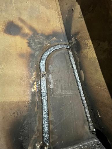 Completed weld seam around a steel insert plate in a ship's hull