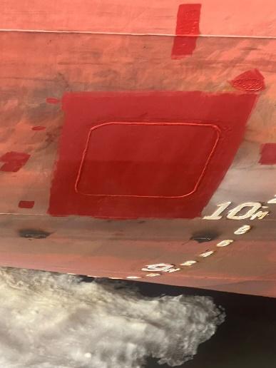 Completed hull insert repair painted over on a ship's shell plating above the waterline