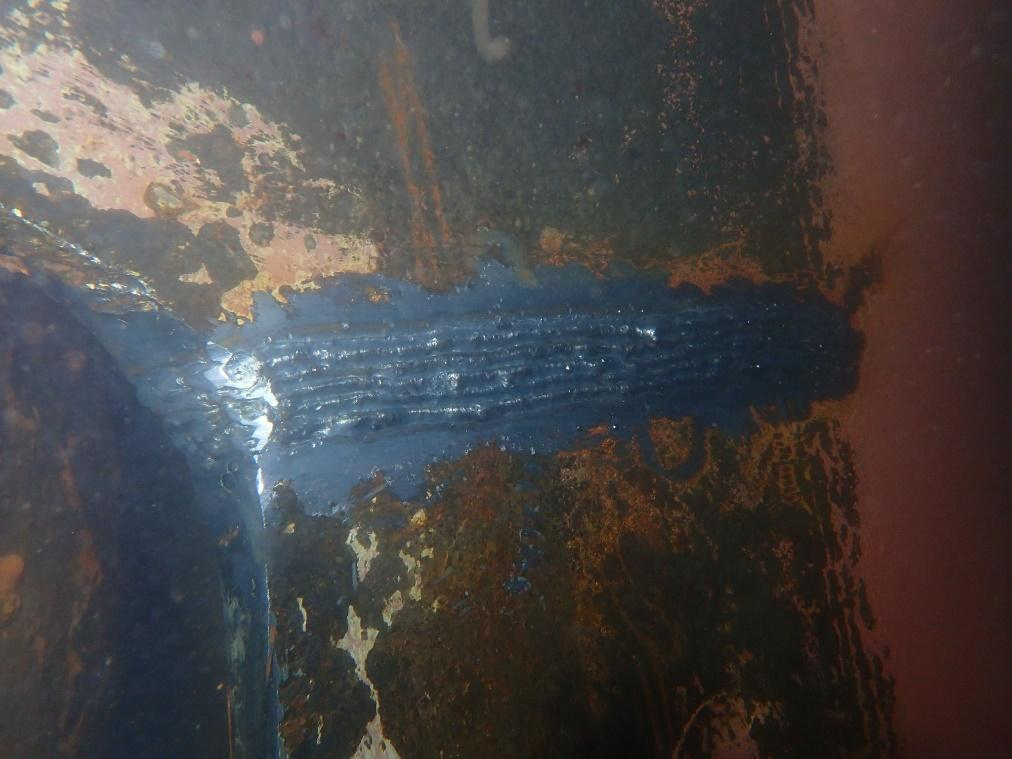 Multi-pass underwater weld on a corroded steel structure below the waterline